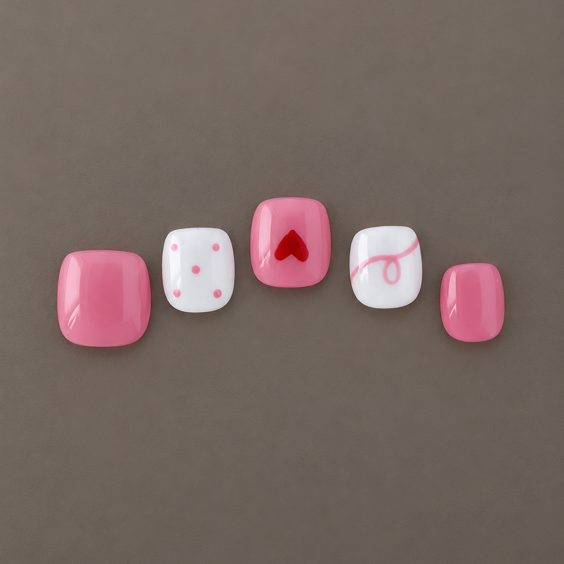 Sweet Recess U.P.O.N Mini hand-painted press-on nails in pink and ivory with dot, heart, and swirl details