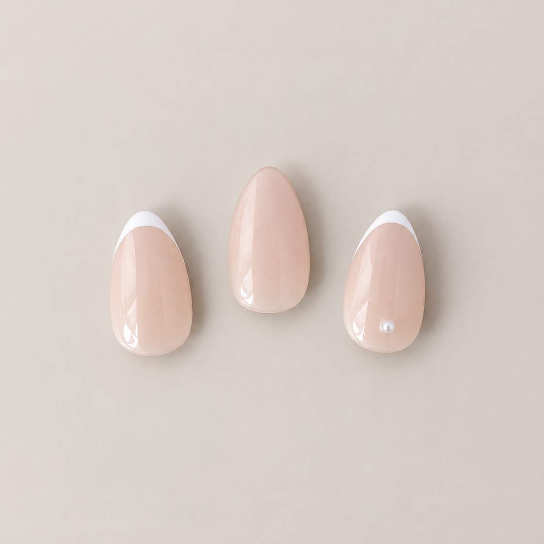 Close-up of French Trace micro-French press-on nails with pearl accent